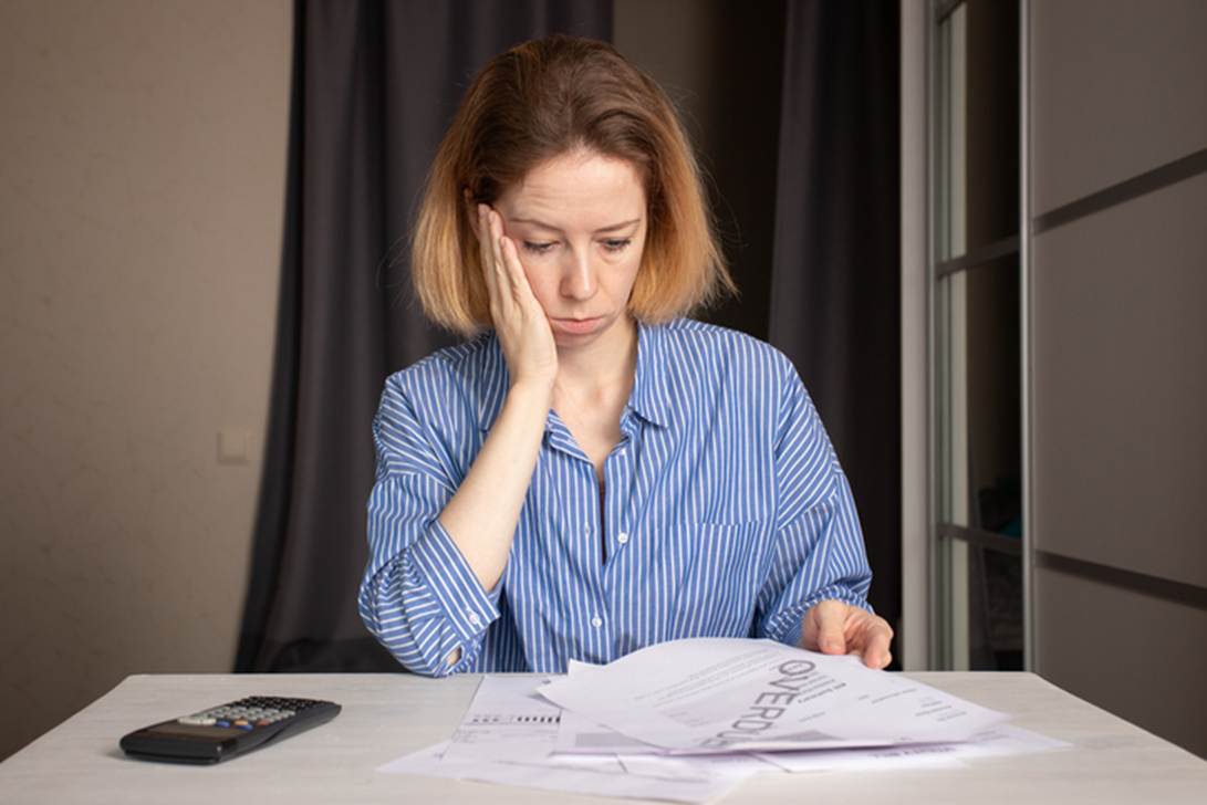 Woman looking over paperwork - Unpaid Wages